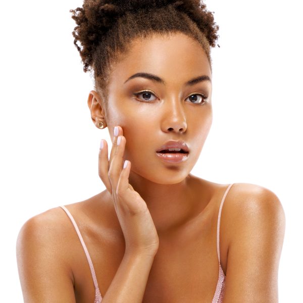 Attractive girl with perfect skin, touching her face. Photo of african girl on white background. Beauty & Skin care concept